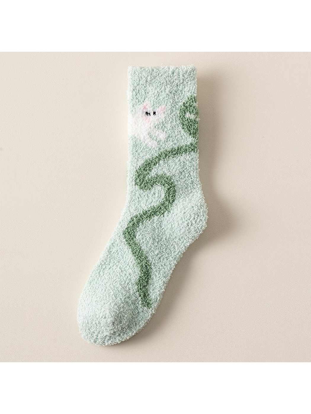 Mint crew sock with white character and winding green motif
