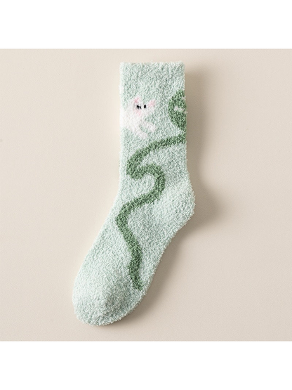 Mint crew sock with white character and winding green motif