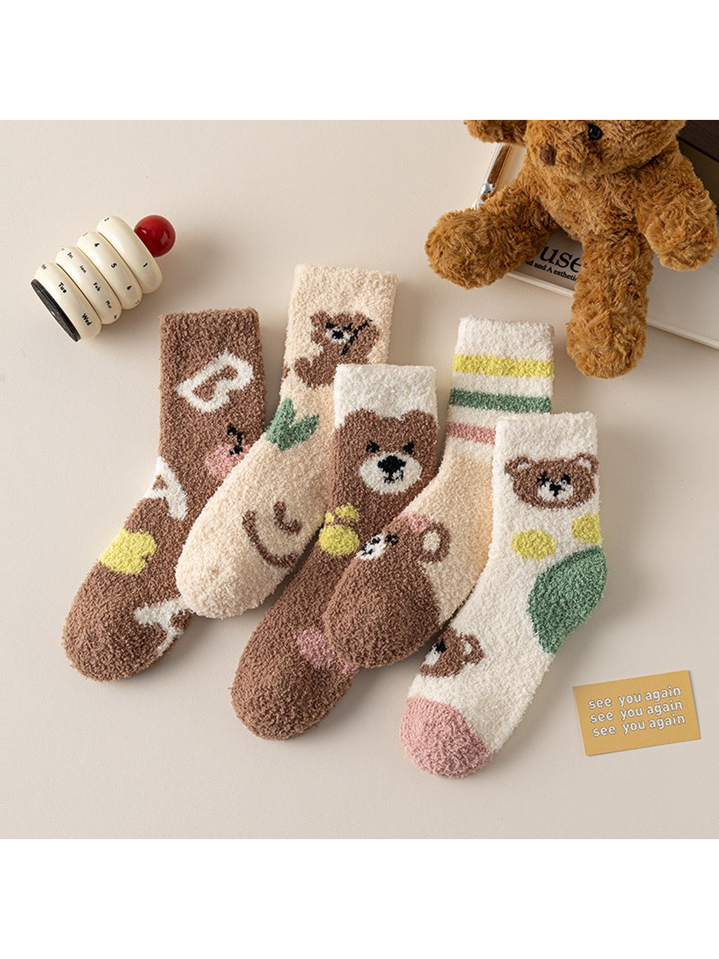 Five fuzzy crew sock designs with bear, heart, paw and striped motifs