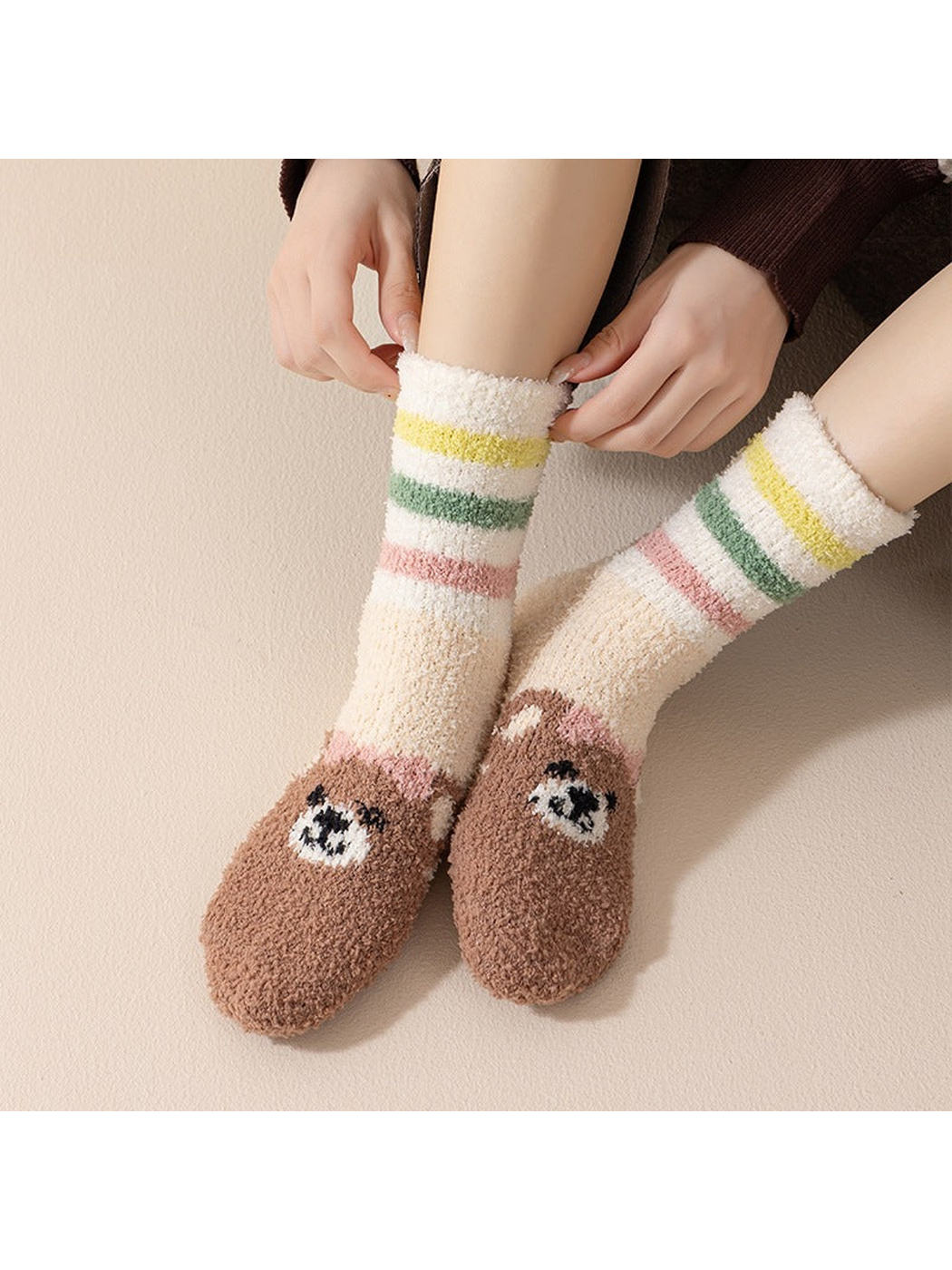 Ivory striped crew socks with brown bear faces across the toes, worn view