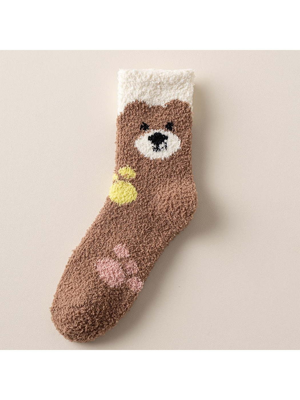 Brown fuzzy crew sock with bear face, yellow accent and pink paw motifs