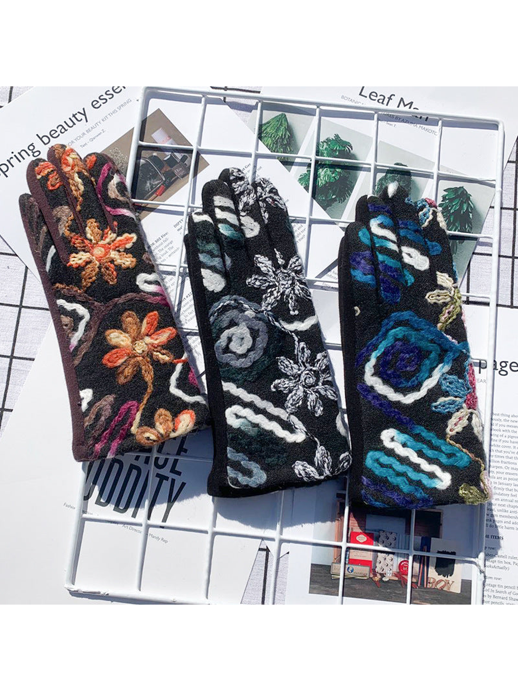 Brown, black and blue floral gloves displayed together