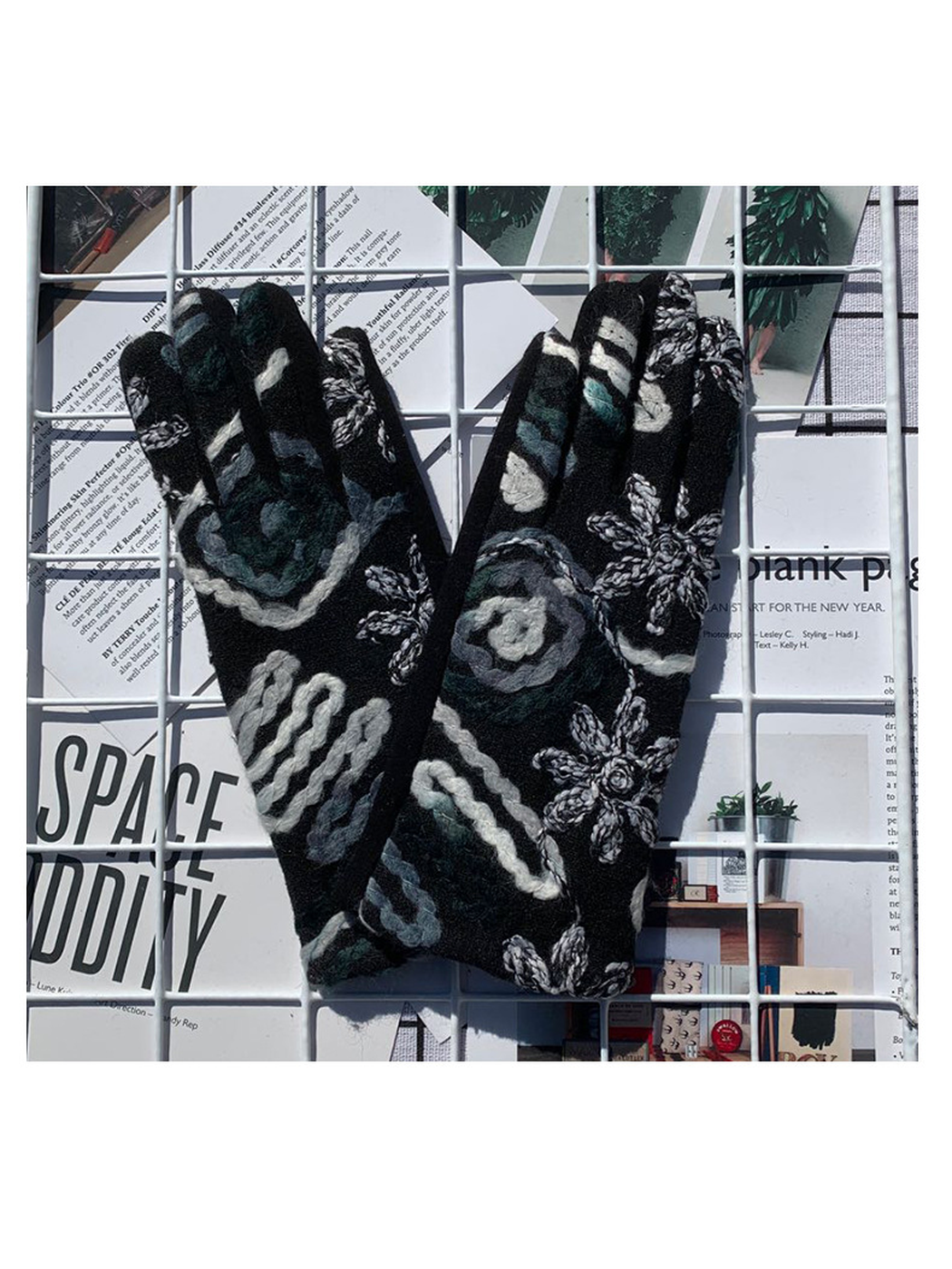 Black and gray floral gloves with raised decoration, back view