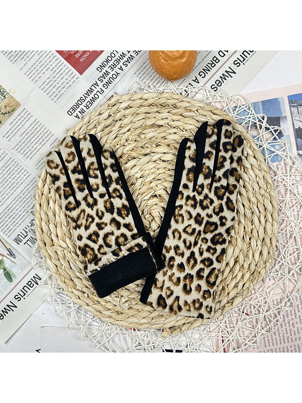 Cream leopard-print gloves with one cuff turned back to reveal the black inner band