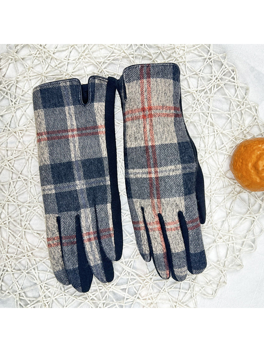 Plaid gloves laid side by side with dark contrast edging
