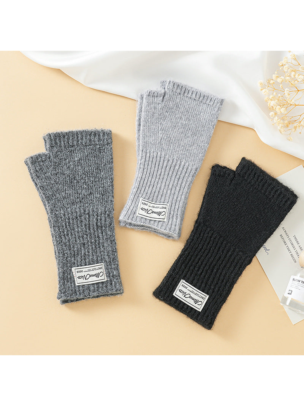 Black, dark gray and light gray fingerless gloves displayed together