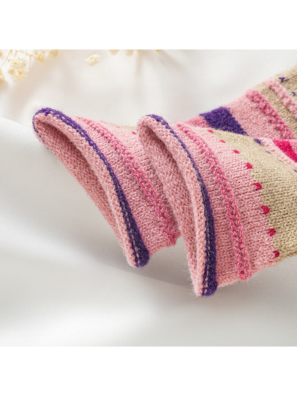 Close-up of contrast-edged finger openings and raised knit seams
