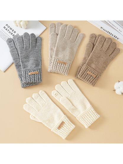 Gray, beige, brown and ivory knit gloves displayed together