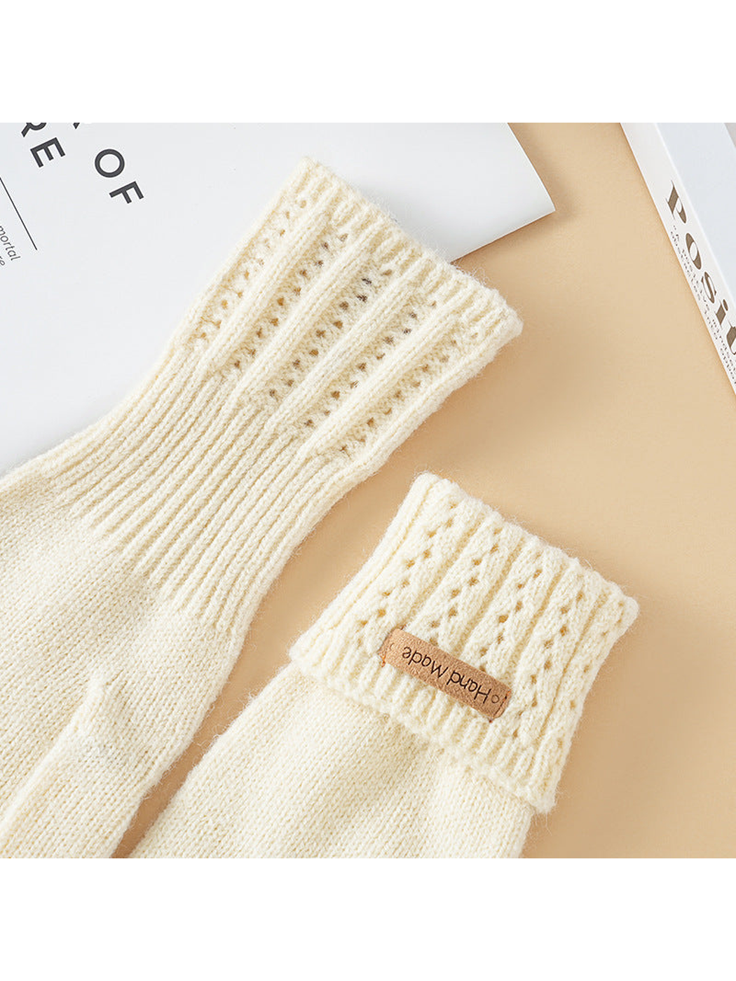 Close-up of extended and folded eyelet-knit glove cuffs