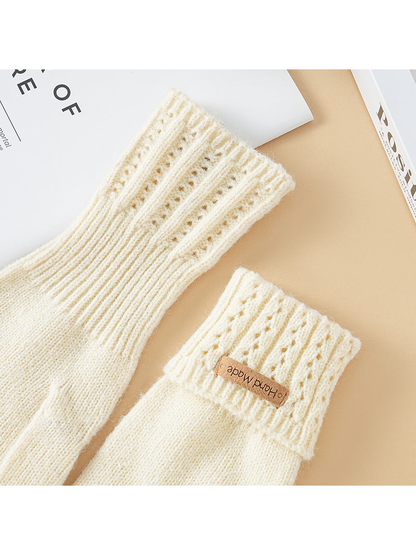 Close-up of extended and folded eyelet-knit glove cuffs