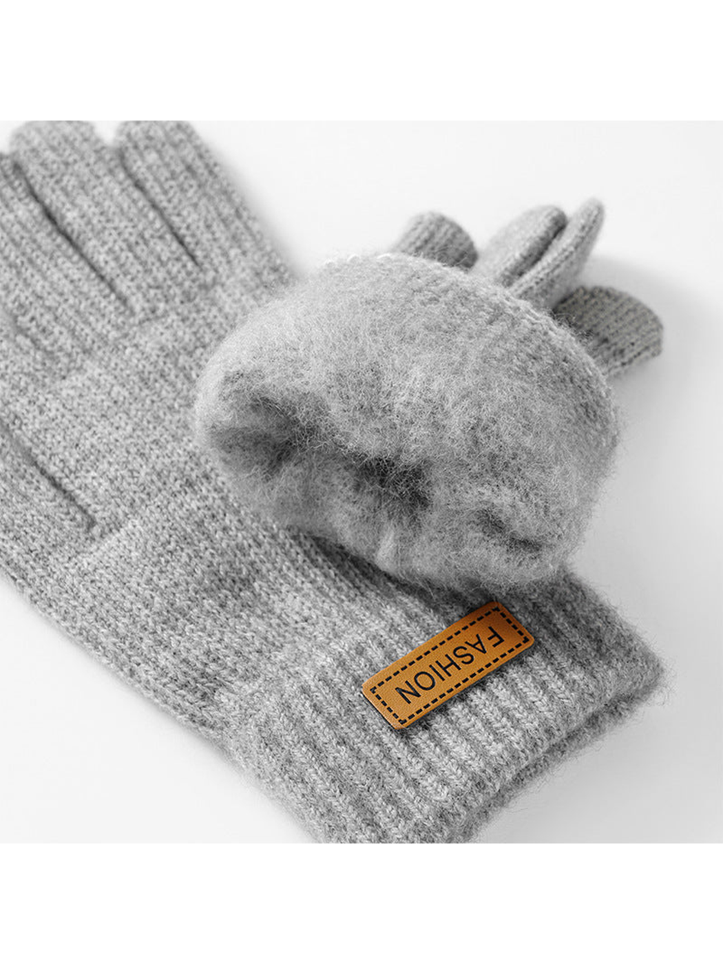 Close-up of the fuzzy interior texture and folded ribbed cuff of gray knit gloves