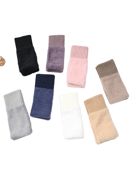 Eight colors of fuzzy fingerless gloves arranged together