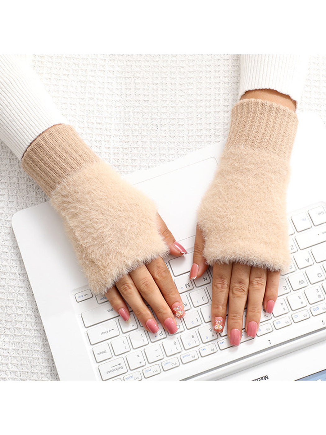 Light khaki fuzzy fingerless gloves worn over the hands