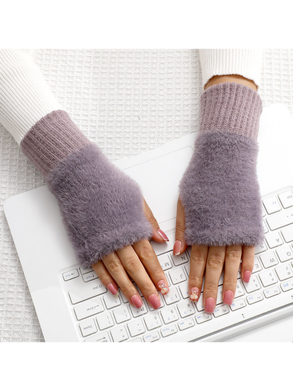 Purple fuzzy fingerless gloves worn over the hands