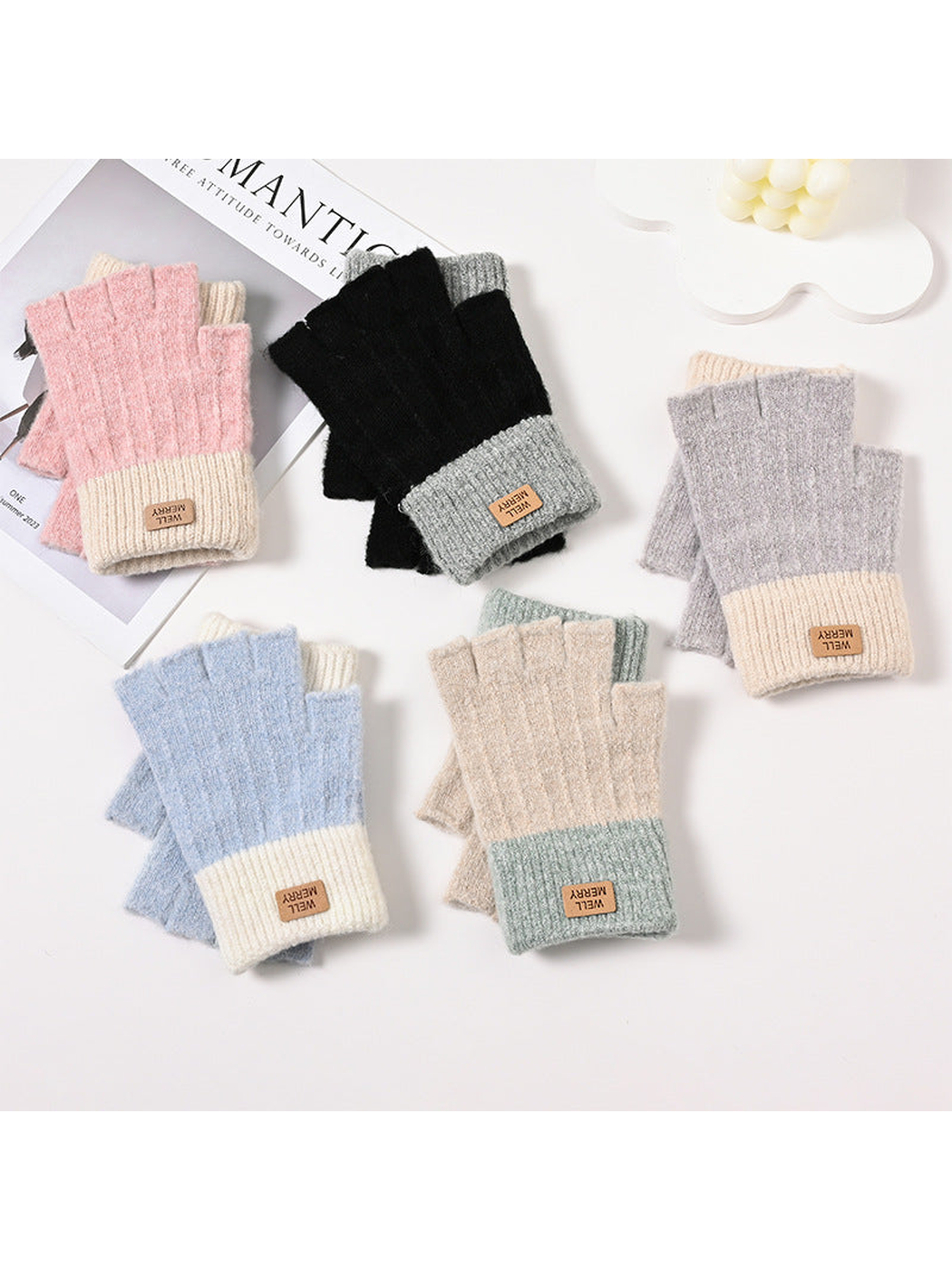 Five pairs of colorblock fingerless gloves arranged with overlapping cuffs