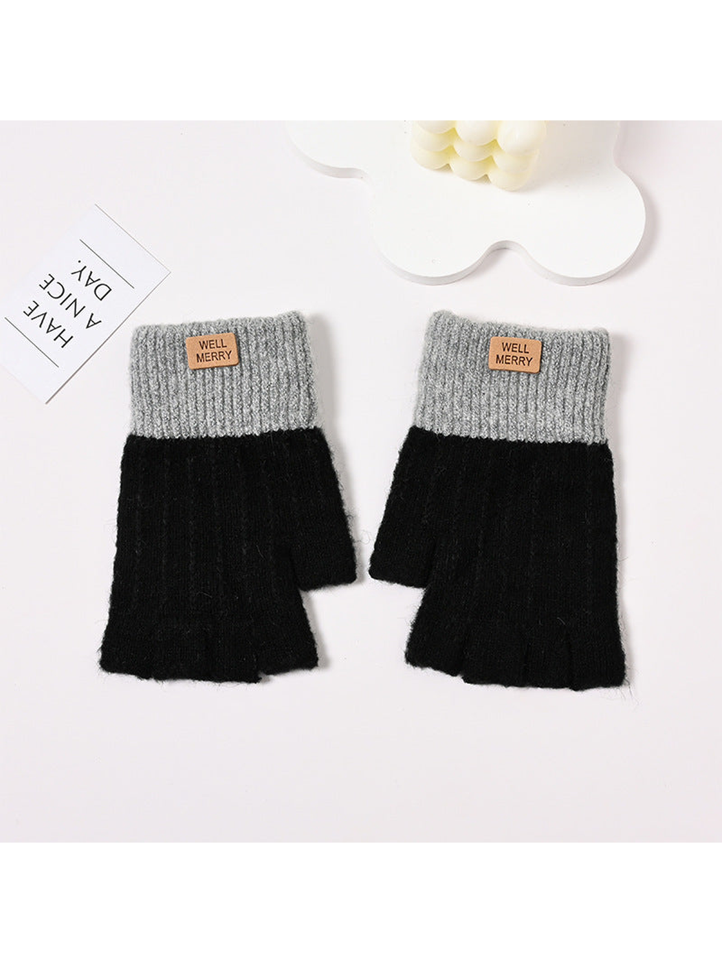 Black fingerless gloves with gray ribbed cuffs