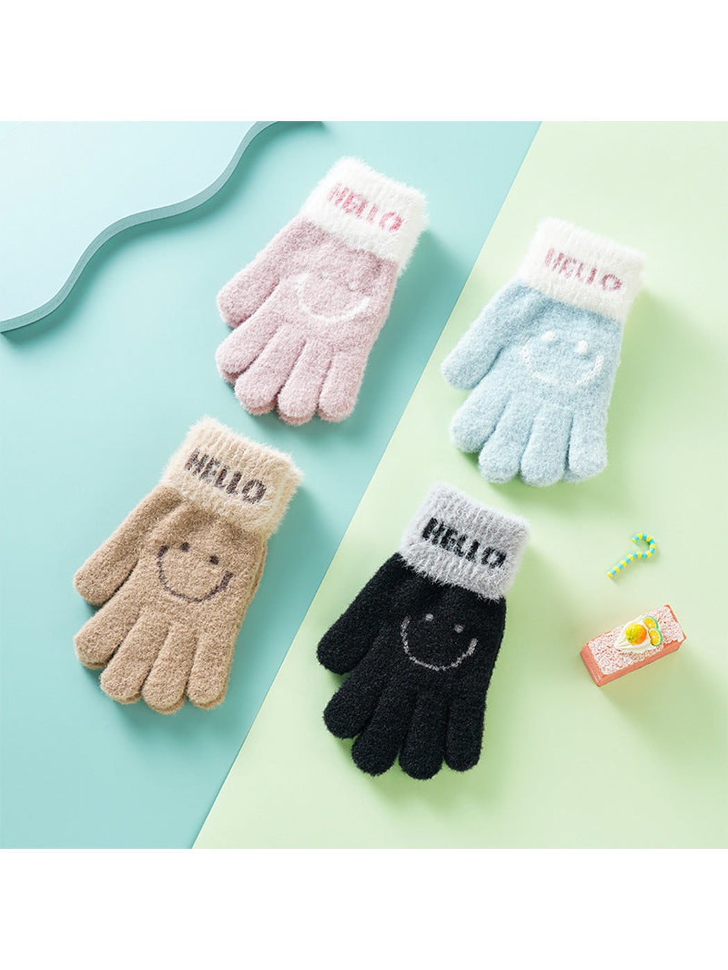 Pink, blue, camel and black fuzzy gloves with smiley motifs displayed together