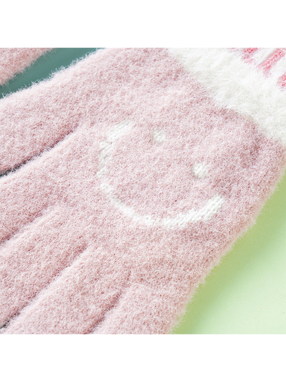 Close-up of the fuzzy pink glove and white smiley motif