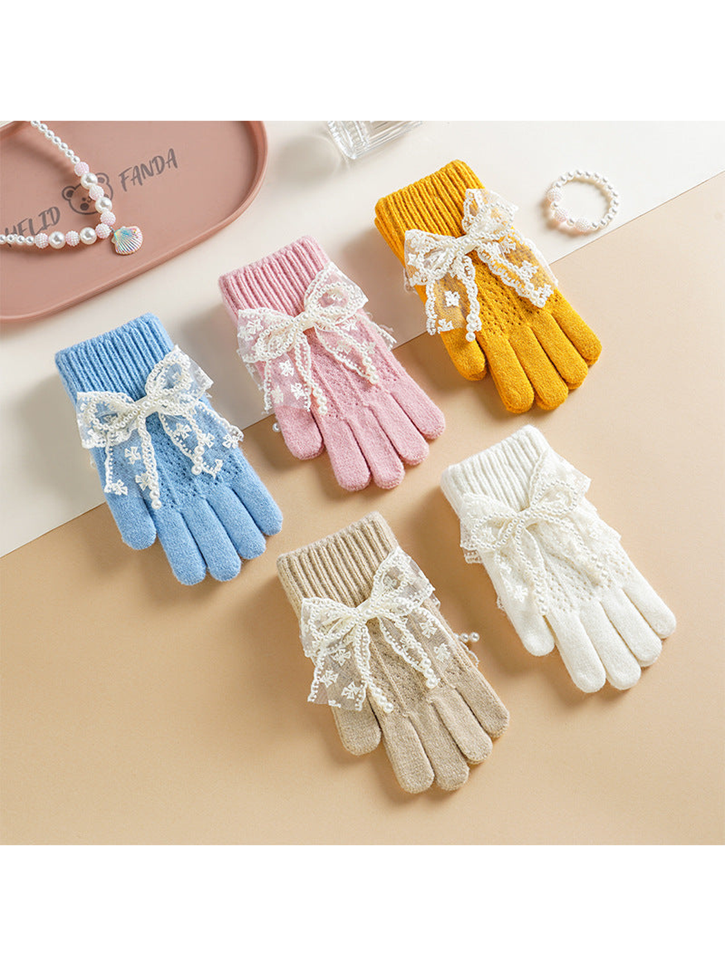 Light blue, pink, yellow, white and beige bow-accent gloves displayed together