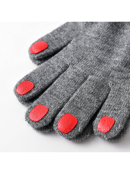 Close-up of red fingertip patches on deep gray knit gloves