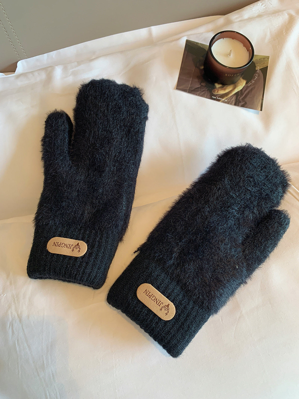 Black fuzzy mittens with ribbed cuffs