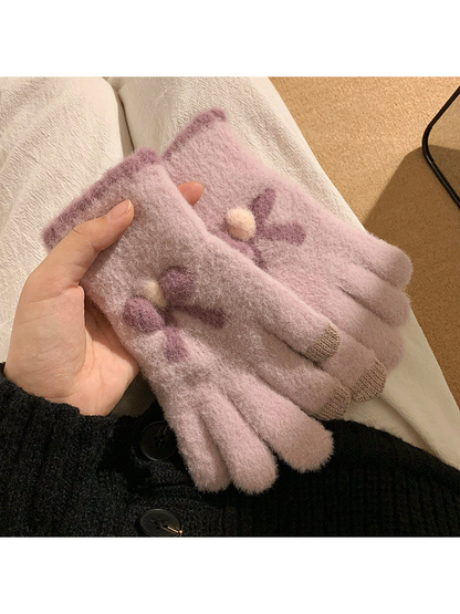 Light purple fuzzy gloves with raised bow motifs