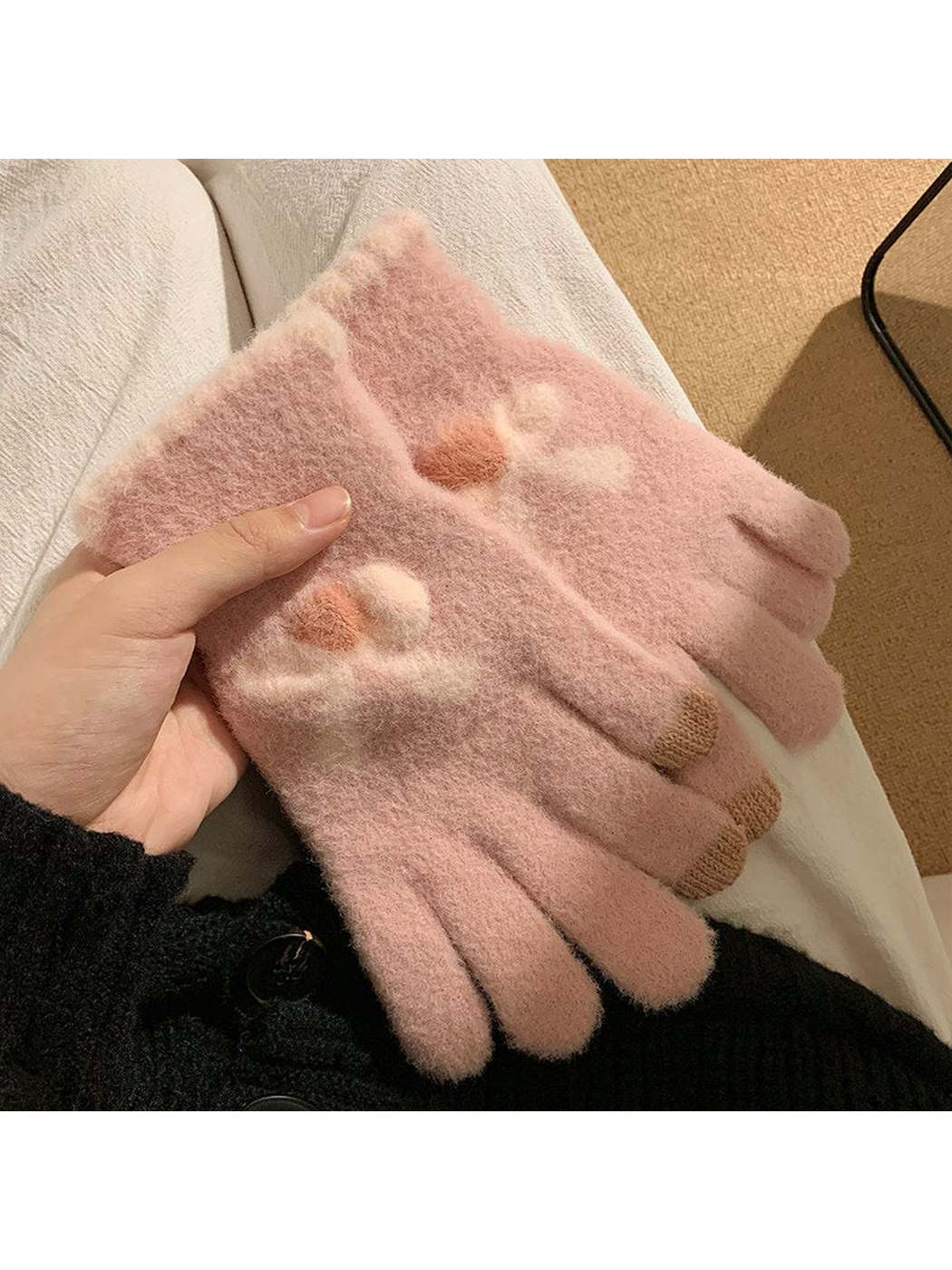 Light pink fuzzy gloves with raised bow motifs