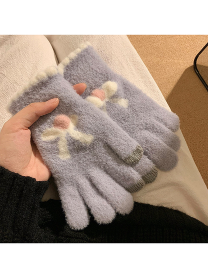 Light blue fuzzy gloves with raised bow motifs
