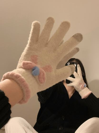 Close-up of an ivory flower-motif glove worn in a mirror scene