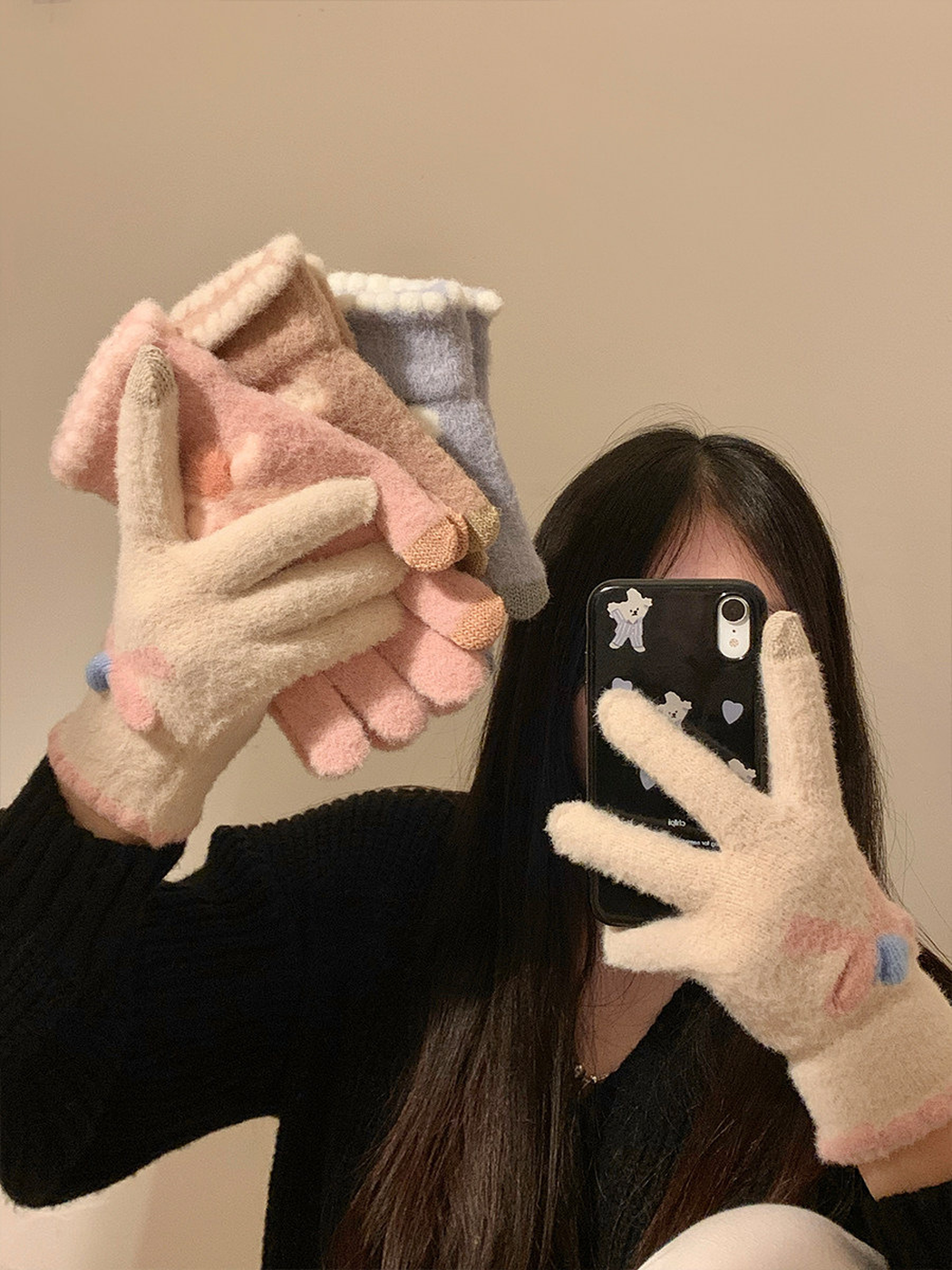 Pink, light coffee and light blue fuzzy gloves displayed with an ivory pair