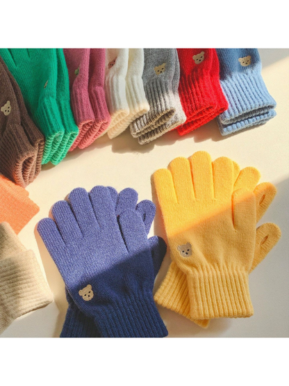 Assorted colors of knit gloves arranged in sunlight