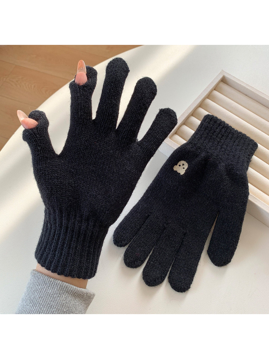 Black knit gloves with open thumb and index fingertips