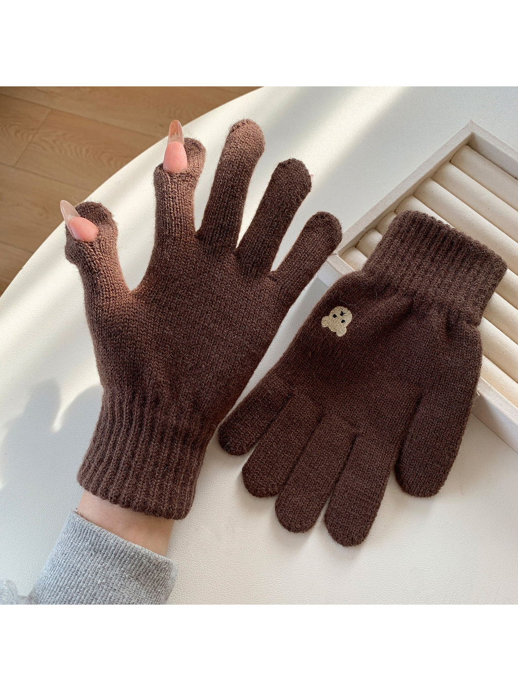Brown knit gloves with open thumb and index fingertips