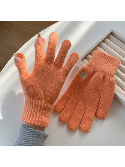 Orange knit gloves with open thumb and index fingertips