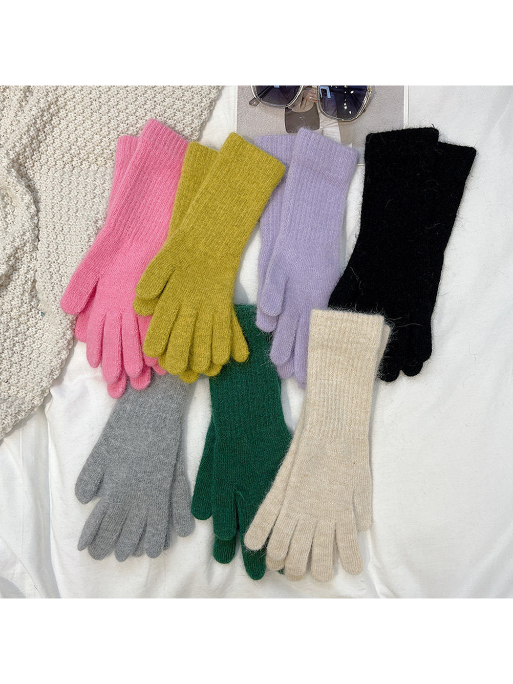 Seven colors of extended-cuff gloves displayed together
