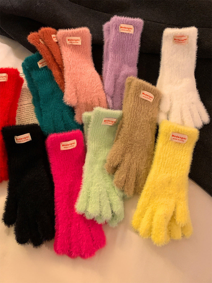 Assorted fuzzy gloves arranged together in multiple colors