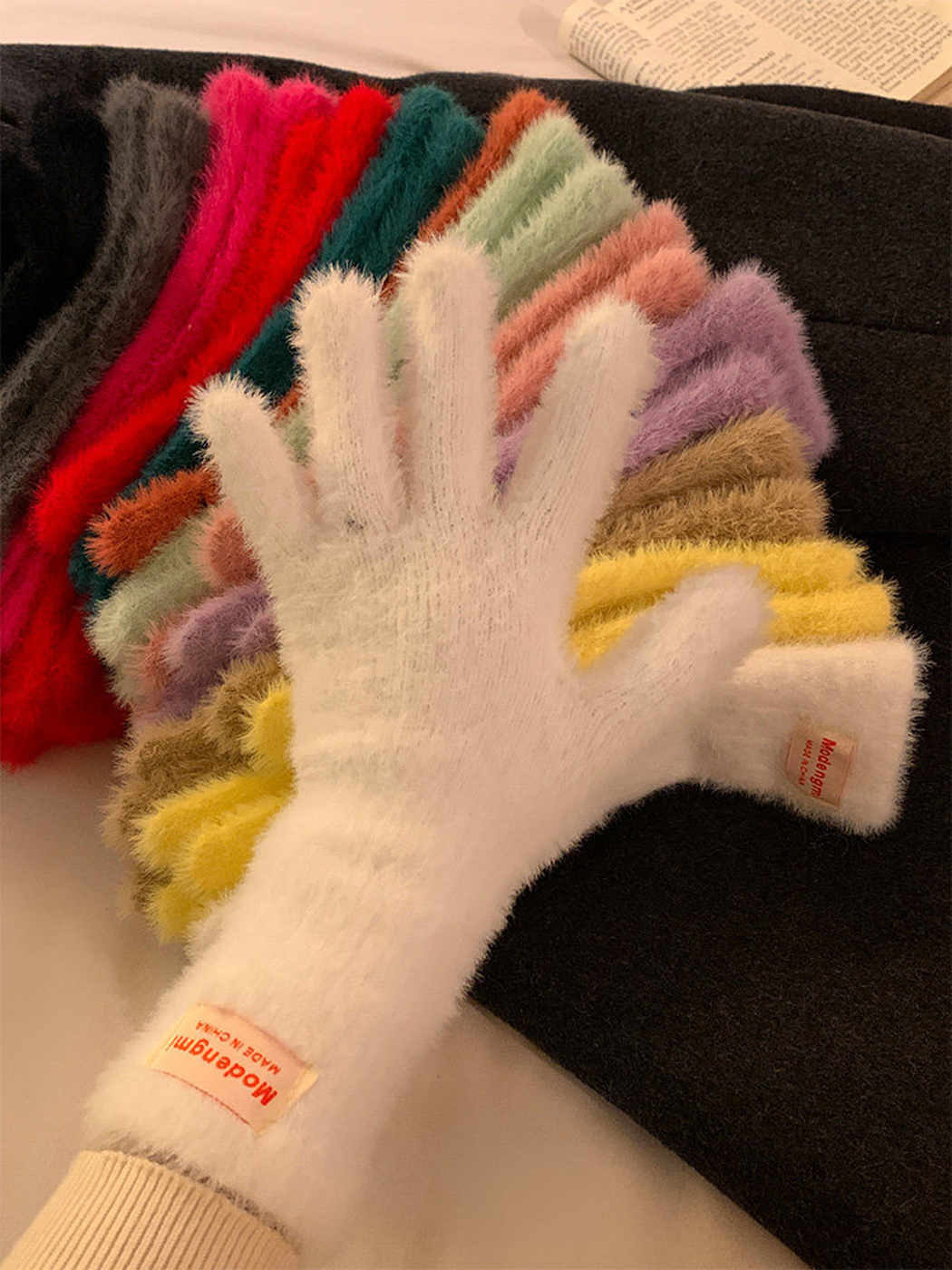 White fuzzy glove layered over an assortment of color options