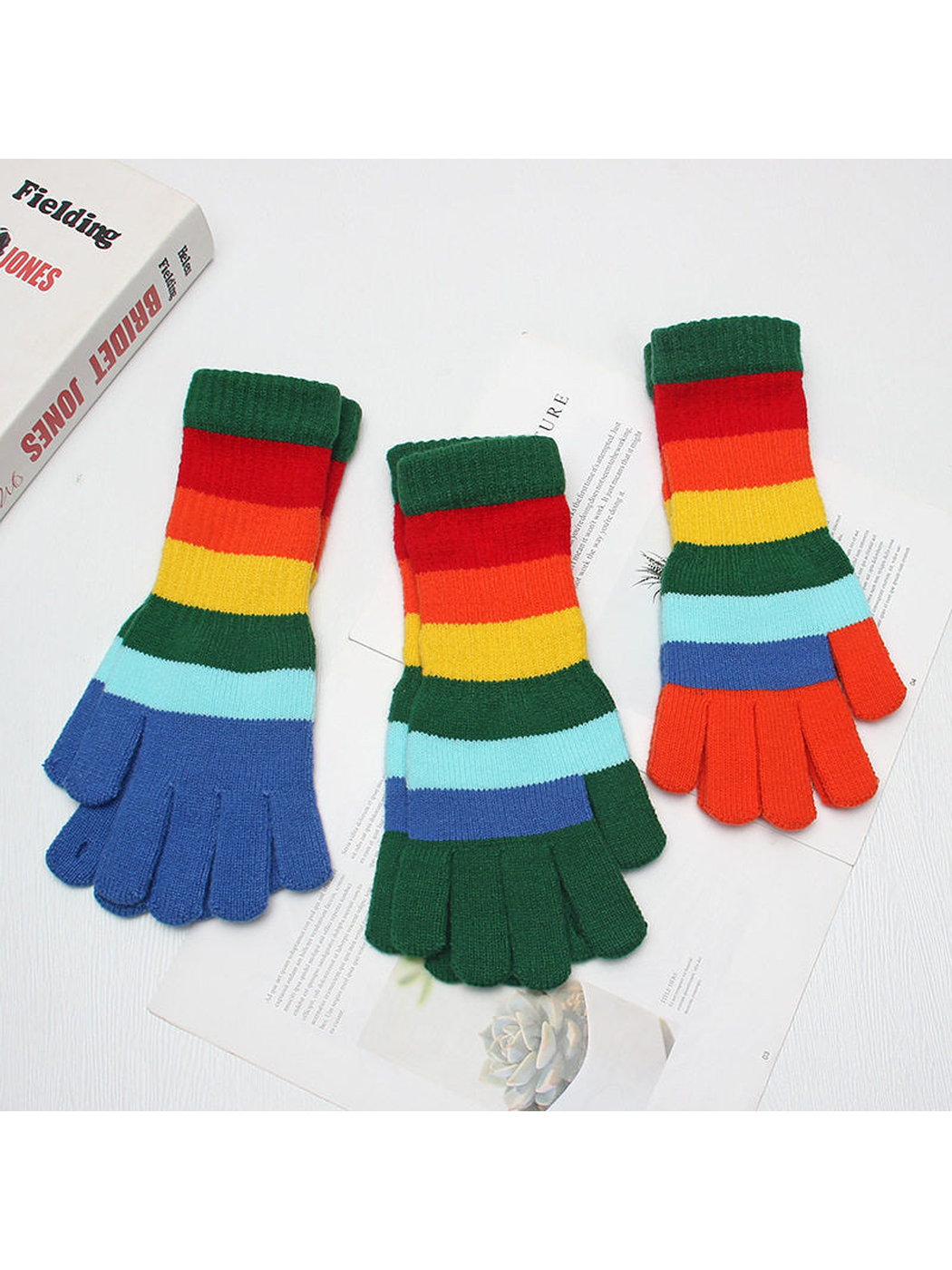 Blue, green and orange-red fingertip glove styles displayed together