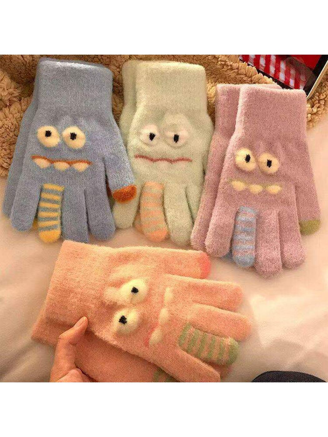 Cartoon face gloves in light blue, mint, purple and pink displayed together