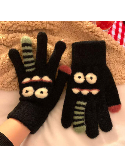 Black fuzzy cartoon face gloves with raised eyes and striped finger details