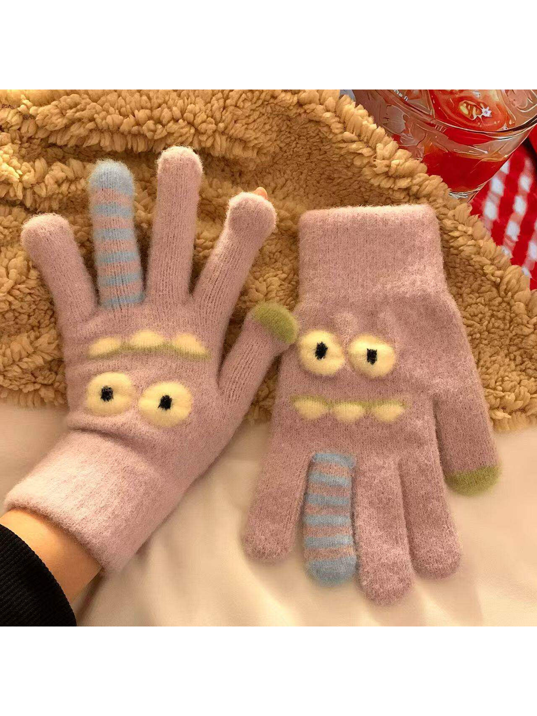 Light purple fuzzy cartoon face gloves with raised eyes and striped finger details
