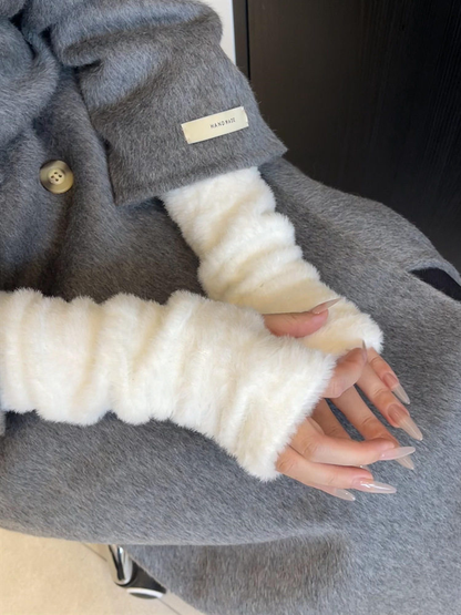 Ivory fuzzy fingerless gloves styled with a gray coat