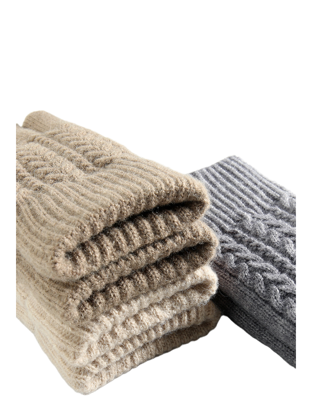 Stacked cable-knit gloves in neutral and gray colors with folded cuffs