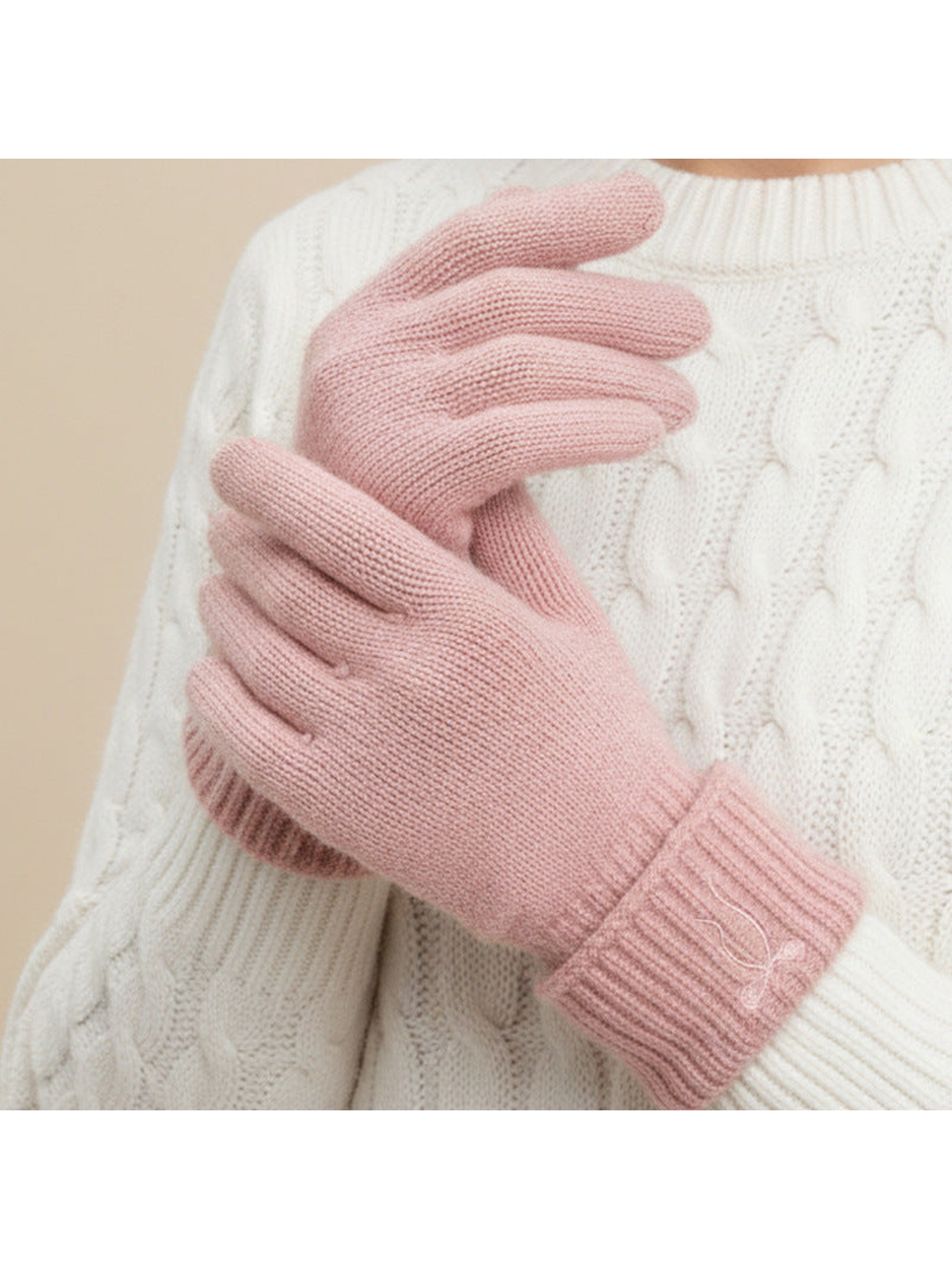 Pink bow-embroidered gloves worn with folded cuffs