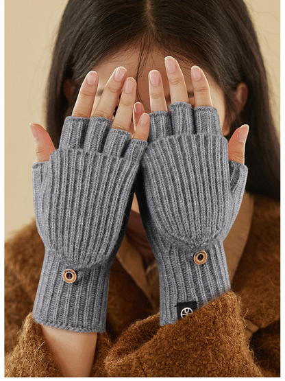 Gray convertible fingerless gloves worn with the mitten flaps folded back