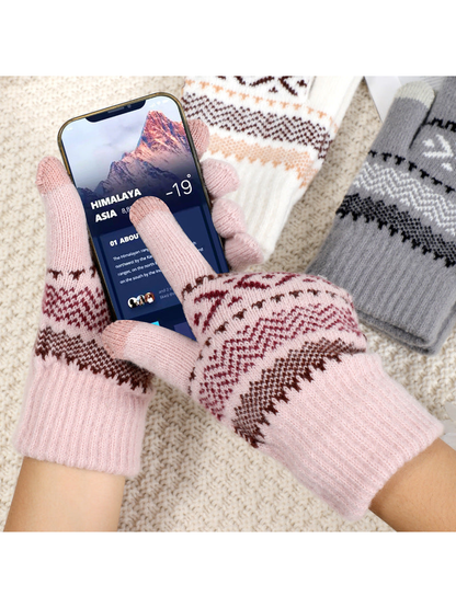 Light pink geometric-pattern gloves holding a smartphone