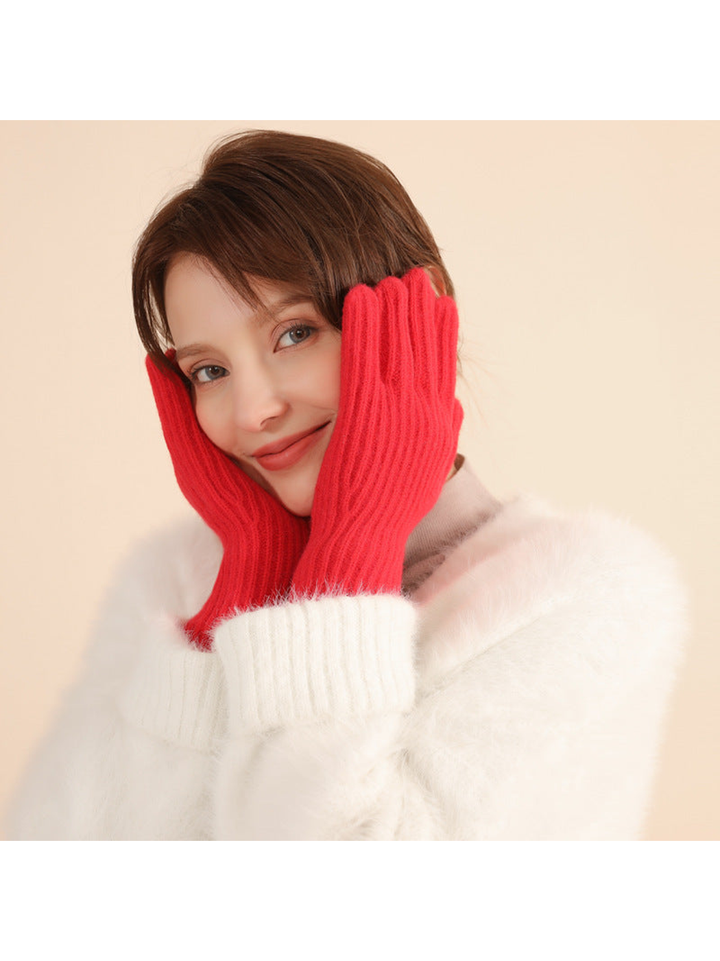 Red ribbed knit gloves worn with a white sweater