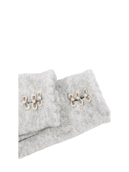 Close-up of scalloped cuffs with three bow accents