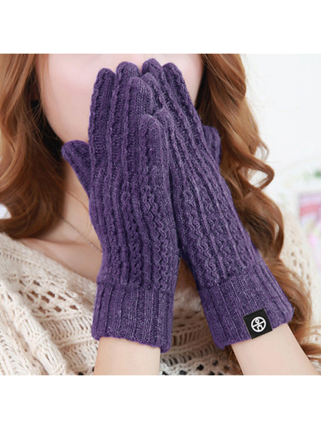 Purple cable-knit gloves worn with the hands raised together