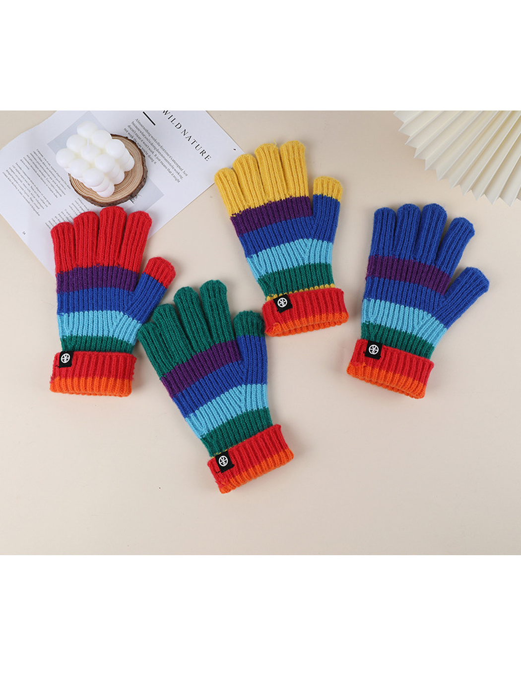 Four rainbow striped glove colors displayed with folded cuffs